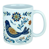 The Nordic Wholesale Mug: Nordic Folk Art Birds Ceramic Mug (11 oz Capacity) is a white Scandinavian-style ceramic mug showcasing a decorative blue bird encircled by detailed floral motifs in blue, orange, and gold hues. It features a plain background and a large handle.
