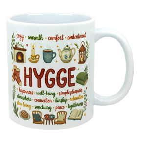 Ceramic coffee cup with the word “HYGGE” and Scandinavian-style illustrations of a fireplace, socks, teapot, chair, and book.