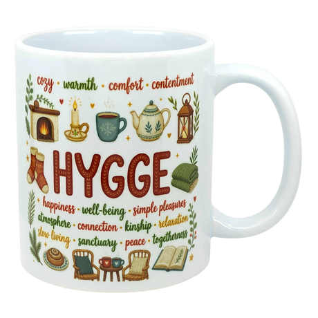 Ceramic coffee cup with the word “HYGGE” and Scandinavian-style illustrations of a fireplace, socks, teapot, chair, and book.
