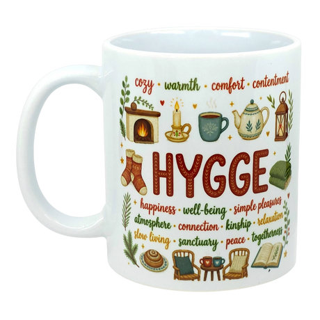White ceramic coffee cup with colorful Nordic illustrations and visible words including “Hygge,” “cozy,” and “warmth.”.