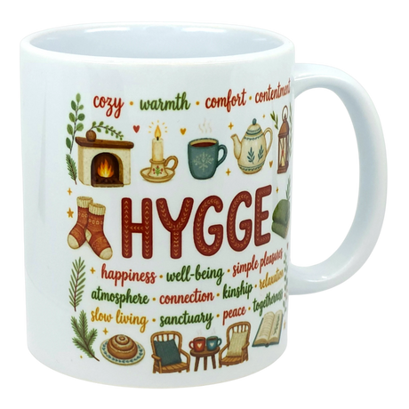 White ceramic mug with “HYGGE” in bold red on the front, surrounded by smaller Scandinavian words including happiness, warmth, and relaxation.