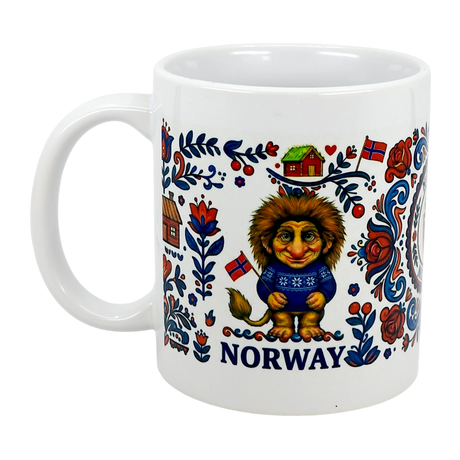 The Swedish Gift Store's 11 oz Norge Norway Rosemaling Troll Wraparound Ceramic Mug features a cheerful Norwegian troll in a blue sweater, red and blue flowers, house, flags, and “NORWAY” printed below—all inspired by Norwegian folklore.