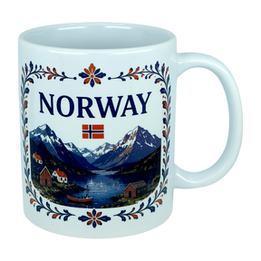 The Nordic Wholesale Mug: Norway Fjord Mountain Ceramic Mug (11 oz Capacity) features the word "NORWAY" and a Norwegian flag above a scenic illustration of mountains, water, boats, and houses, all framed by blue and orange floral patterns inspired by traditional rosemaling. This ceramic mug beautifully celebrates Norwegian heritage with its intricate design.