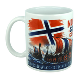 The Norway Soccer Coffee Cup Mug – Viking Longship Fan Mug by Swedish Gift Store features the Norwegian flag, Viking longships with distinctive striped sails, and bold "NORWAY SOCCER" text. This unique mug is ideal for fans who cherish both Norway’s Viking heritage and contemporary soccer.