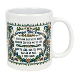 The Nordic Wholesale Mug: Norwegian Table Prayer Ceramic Rosemaling Mug (11 oz) features colorful floral patterns and the Norwegian Table Prayer in both Norwegian and English—an ideal gift for celebrating Norwegian heritage.