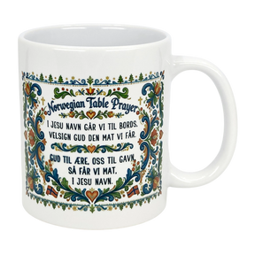 The Nordic Wholesale Mug: Norwegian Table Prayer Ceramic Rosemaling Mug (11 oz) features colorful floral patterns and the Norwegian Table Prayer in both Norwegian and English—an ideal gift for celebrating Norwegian heritage.