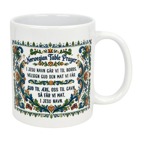 The Nordic Wholesale Mug: Norwegian Table Prayer Ceramic Rosemaling Mug (11 oz) features colorful floral patterns and the Norwegian Table Prayer in both Norwegian and English—an ideal gift for celebrating Norwegian heritage.