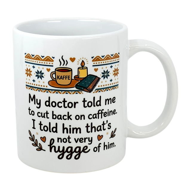 The Swedish Gift Store's 11 oz "Not Very Hygge" Coffee Mug features Nordic patterns and text: My doctor told me to cut back on caffeine. I told him that's not very Scandinavian humor—or hygge coffee mug—of him.