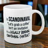 The Swedish Gift Store’s 11 oz Mug: Scandinavia Coffee Legally Binding Emotional Contract features black text on white ceramic: “In SCANDINAVIA, ‘Let’s grab a coffee’ isn’t an invitation. It’s a LEGALLY BINDING EMOTIONAL CONTRACT.”.