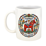 The Swedish Gift Store's "Sverige Dala Häst" Mug features a red Dala horse with a Swedish folk art wreath and the words Sverige and Dalahäst, printed on an 11 oz ceramic mug.