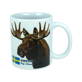 Start your day with a touch of Nordic nature using the Mug: Sweden Älg Moose Ceramic Mug (11 oz) from Nordic Wholesale. Featuring a photo of a moose, the Swedish flag, and the text “SWEDEN Älg | Moose” on a plain white background, this stylish ceramic mug is a charming addition to any Scandinavian kitchen.