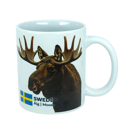 Start your day with a touch of Nordic nature using the Mug: Sweden Älg Moose Ceramic Mug (11 oz) from Nordic Wholesale. Featuring a photo of a moose, the Swedish flag, and the text “SWEDEN Älg | Moose” on a plain white background, this stylish ceramic mug is a charming addition to any Scandinavian kitchen.