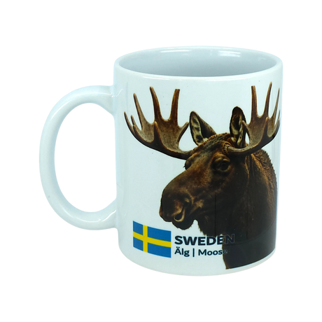 The Mug: Sweden Älg Moose Ceramic Mug (11 oz) by Nordic Wholesale features a white design with a photo of a moose's head, the Swedish flag, and the words "SWEDEN Älg | Moose" printed on it—making it a charming addition to any Scandinavian kitchen and an ideal tribute to Nordic nature.