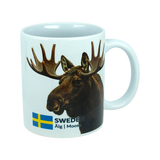 The Mug: Sweden Älg Moose Ceramic Mug (11 oz) by Nordic Wholesale features a white ceramic design adorned with a moose head, the Swedish flag, and the text "SWEDEN Älg | Moose" on the side. This stylish mug is a charming addition to any Scandinavian kitchen, capturing the essence of Nordic nature in your daily routine.