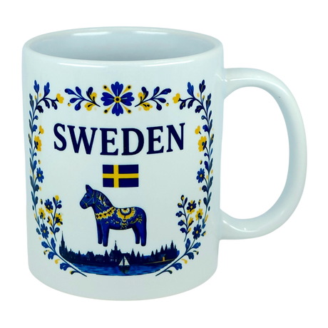 The Nordic Wholesale Mug: Sweden Dala Horse Ceramic Mug (11 oz Capacity) features blue and yellow floral designs, the word "SWEDEN," a small Swedish flag, and a traditional blue Dala horse above a silhouette of buildings—beautifully celebrating Swedish heritage in this charming Scandinavian folk mug.