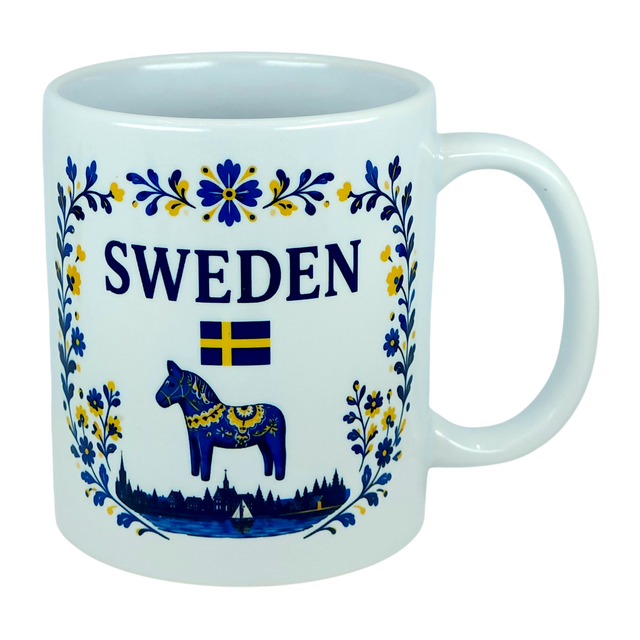 The Nordic Wholesale Mug: Sweden Dala Horse Ceramic Mug (11 oz Capacity) features blue and yellow floral designs, the word "SWEDEN," a small Swedish flag, and a traditional blue Dala horse above a silhouette of buildings—beautifully celebrating Swedish heritage in this charming Scandinavian folk mug.