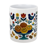 The Swedish Gift Store’s 11 oz ceramic "Swedish Fika Traditions" mug features colorful folk art—blue birds, flowers, pastries, cookies, a steaming cup—and Spanish text.