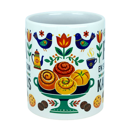 Celebrate Swedish coffee traditions with the Mug: Fika — "En Svensk Tradition Kaffepaus" Swedish Fika Traditions Wraparound Ceramic Mug (11 oz) by Nordic Wholesale. This white ceramic mug is adorned with vibrant folk art depicting birds, flowers, a pedestal of pastries, and cookies in bright patterns and warm hues. Its festive and cozy design makes it an ideal gift for those who cherish Swedish traditions or a charming Scandinavian coffee mug for elevating your daily fika rituals.