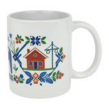 Brighten your table with the Nordic Wholesale Mug: Swedish Folk Art — Blue Dala Horse, Church & Red House. This 11oz ceramic mug features charming Scandinavian folk art motifs, including a red house, blue Dala horse, church, floral details, green leaves, and intricate geometric patterns—perfect for adding a touch of traditional Swedish style to your daily routine.