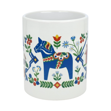 The Nordic Wholesale Mug: Swedish Folk Art — Blue Dala Horse, Church & Red House is an 11oz ceramic mug adorned with a vibrant folk art design featuring a blue Dala horse, colorful flowers, a charming red house, and decorative patterns in red, green, and yellow—a perfect addition to bring Swedish charm to your coffee or tea routine.