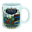 The Nordic Wholesale Mug: Swedish Gift Store America's Little Sweden Ceramic Mug (11 oz) is a white ceramic mug in a charming Nordic style, featuring colorful illustrations of Lindström, Minnesota—including the town’s iconic water tower, Swedish horse, local store, statues, and floral patterns. The mug displays the text "America's Little Sweden, Lindström, MN," making it a perfect Swedish-American gift for celebrating your heritage or love of Scandinavian design.
