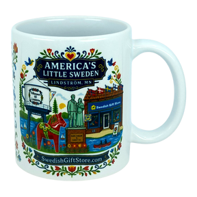 The Nordic Wholesale Mug: Swedish Gift Store America's Little Sweden Ceramic Mug (11 oz) is a white ceramic mug in a charming Nordic style, featuring colorful illustrations of Lindström, Minnesota—including the town’s iconic water tower, Swedish horse, local store, statues, and floral patterns. The mug displays the text "America's Little Sweden, Lindström, MN," making it a perfect Swedish-American gift for celebrating your heritage or love of Scandinavian design.