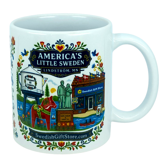 The Nordic Wholesale Mug: Swedish Gift Store America's Little Sweden Ceramic Mug (11 oz) is a white ceramic mug in a charming Nordic style, featuring colorful illustrations of Lindström, Minnesota—including the town’s iconic water tower, Swedish horse, local store, statues, and floral patterns. The mug displays the text "America's Little Sweden, Lindström, MN," making it a perfect Swedish-American gift for celebrating your heritage or love of Scandinavian design.
