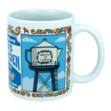 The Nordic Wholesale "Mug: Swedish Gift Store America’s Little Sweden Wraparound Ceramic Mug (11 oz)" features a charming illustration of a teapot-shaped water tower with “Välkommen till Lindström” displayed on it, surrounded by floral borders and set against a blue sky with clouds—a delightful tribute to Swedish-American heritage.
