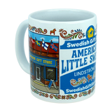 Enjoy your favorite beverage with the Mug: Swedish Gift Store America's Little Sweden Wraparound Ceramic Mug (11 oz) by Nordic Wholesale. This white ceramic mug features a vibrant storefront labeled "Swedish Gift Store," highlighted by Scandinavian flags, decorative Swedish folk art, and a delightful Dala horse design. The text reads "America's Little Sweden" and "Lindström," making it the perfect piece to celebrate your Swedish-American heritage.