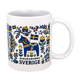 The Nordic Wholesalers Mug: Swedish Icons & Dala Horse Folk Art Ceramic Mug (11 oz) features Swedish folk art with a blue Dala horse, yellow and blue flags, flowers, houses, and "Sverige" beneath the charming design.