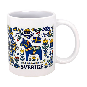The Nordic Wholesalers Mug: Swedish Icons & Dala Horse Folk Art Ceramic Mug (11 oz) features Swedish folk art with a blue Dala horse, yellow and blue flags, flowers, houses, and "Sverige" beneath the charming design.