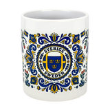 The Nordic Wholesalers Mug: Swedish Icons & Dala Horse Folk Art Ceramic Mug (11 oz) features blue and yellow folk art, a three crowns crest, floral motifs, small Swedish flags, and the words Sverige Sweden.