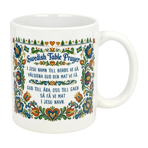 The Nordic Wholesale 11 oz Swedish Table Prayer Ceramic Kurbits Mug features colorful Swedish folk art, Kurbits floral design, small Swedish flags, and the Table Prayer printed in both Swedish and English at the center.