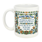 The Mug: Swedish Table Prayer Ceramic Kurbits Mug (11 oz) by Nordic Wholesale features the Swedish Table Prayer in both languages with vibrant floral and heart motifs—a meaningful heritage gift.