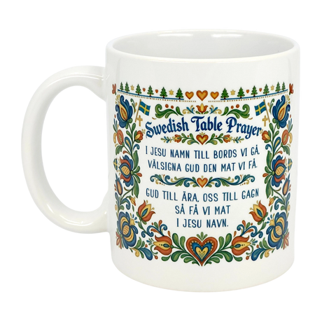 The Mug: Swedish Table Prayer Ceramic Kurbits Mug (11 oz) by Nordic Wholesale features the Swedish Table Prayer in both languages with vibrant floral and heart motifs—a meaningful heritage gift.