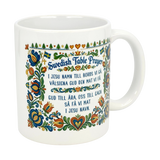 The Nordic Wholesale Mug: Swedish Table Prayer Ceramic Kurbits Mug (11 oz) features a colorful Kurbits floral design, Swedish flags, and the Swedish Table Prayer in both Swedish and English.