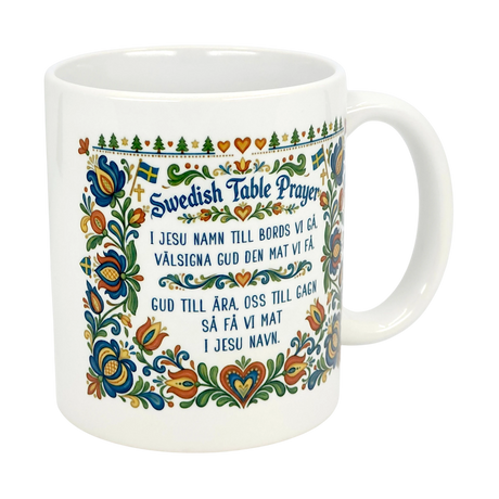 The Nordic Wholesale Mug: Swedish Table Prayer Ceramic Kurbits Mug (11 oz) features a colorful Kurbits floral design, Swedish flags, and the Swedish Table Prayer in both Swedish and English.