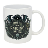 The Nordic Wholesale Mug: This Is My Raiding Mug Viking Ceramic Mug (11 oz) is a white ceramic mug with a dragon, wolf, and bear around a shield reading "This Is My Raiding Mug," surrounded by Norse and Viking-style designs.