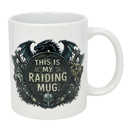 The Nordic Wholesale Mug: This Is My Raiding Mug Viking Ceramic Mug (11 oz) is a white ceramic mug with a dragon, wolf, and bear around a shield reading "This Is My Raiding Mug," surrounded by Norse and Viking-style designs.