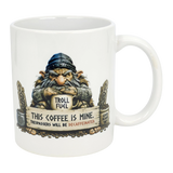 The Mug: Troll Fuel Ceramic Coffee Mug (11 oz) by Nordic Wholesale features a cartoon troll in a blue hat with a "TROLL FUEL" sign and bold warning: THIS COFFEE IS MINE. TRESPASSERS WILL BE DECAFFEINATED, plus decorative stones and Nordic folklore symbols.