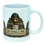 The Mug: Troll Fuel Ceramic Coffee Mug (11 oz Capacity) by Nordic Wholesale is a white ceramic mug featuring a grumpy troll inspired by Nordic folklore, holding a cup labeled "Troll Fuel" with the warning: "This coffee is mine. Trespassers will be decaffeinated." Decorative accents and coffee beans surround the troll, making this Scandinavian-themed mug both whimsical and bold.