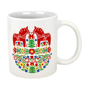The Swedish Gift Store’s 11oz ceramic mug features two red Dala horses facing each other amid colorful Swedish folk flowers.