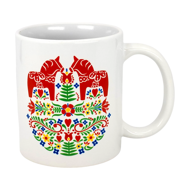 The Swedish Gift Store’s 11oz ceramic mug features two red Dala horses facing each other amid colorful Swedish folk flowers.