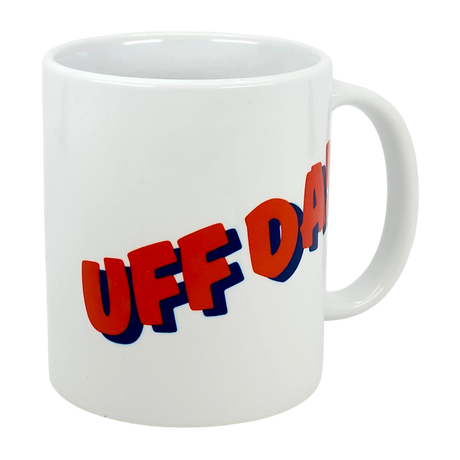 The Mug: Classic "Uff Da!" Ceramic Mug (11 oz) by Nordic Wholesale is a white ceramic mug printed with the bold phrase "UFF DA!" in red letters outlined in blue.