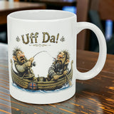 The Mug: Uff Da Fishing Trolls Ceramic Mug (11 oz) by Nordic Wholesale features two cartoon trolls fishing in a boat with a Norwegian flag and “Uff Da!” text—an ideal collectible for fans of Scandinavian designs.