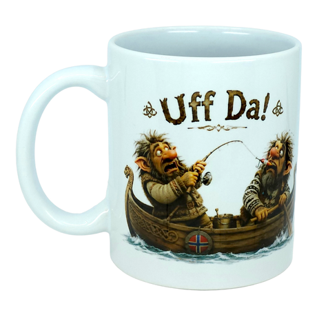 The Mug: Uff Da Fishing Trolls Ceramic Mug (11 oz Capacity) by Nordic Wholesale features two cartoon trolls fishing from a wooden boat with a Norwegian flag. Above them, the large playful text reads “Uff Da!”—making this ceramic mug ideal for anyone who enjoys Scandinavian humor and charming designs.