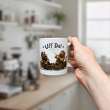 A hand holds the Nordic Wholesale Mug: Uff Da Fishing Trolls Ceramic Mug (11 oz Capacity), featuring cartoon Vikings in a boat with the text "Uff Da!" against a blurred kitchen backdrop with shelves and a window.