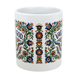 The Mug: Var Sa God Swedish Kurbits Folk Art Ceramic Mug (11 oz) by Nordic Wholesalers features colorful, symmetrical floral Nordic designs and the text "GOD" and "VAR," making it a perfect Scandinavian-style coffee cup.