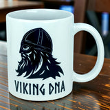 Introducing the Mug: Viking DNA White Ceramic Mug with Historically Accurate Helmet (11 oz) from Nordic Wholesale. This striking white coffee mug features a detailed black illustration of a historically accurate Viking helmet and bearded face, boldly accented with “VIKING DNA” beneath the image. Perfect for anyone embracing their Scandinavian heritage, this Nordic Wholesale mug is an ideal addition to your collection or a thoughtful gift for those proud of their roots.