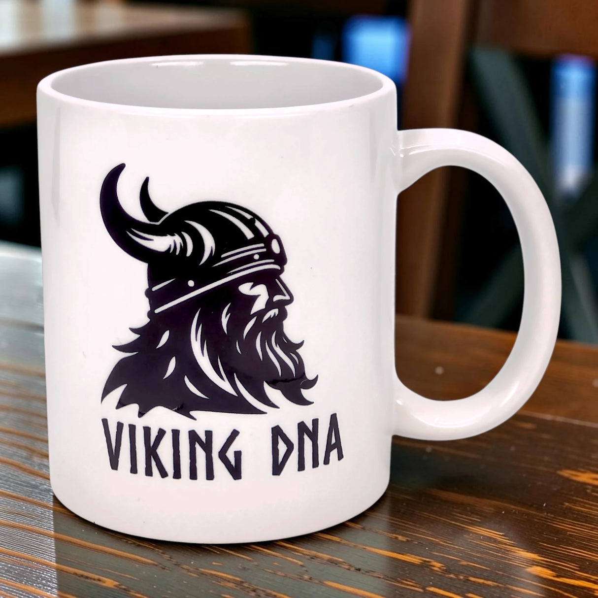The Swedish Gift Store’s 11 oz white ceramic "Viking DNA" mug features a black graphic of a horned-helmet Viking and the words VIKING DNA, perfect for celebrating proud Scandinavian heritage.